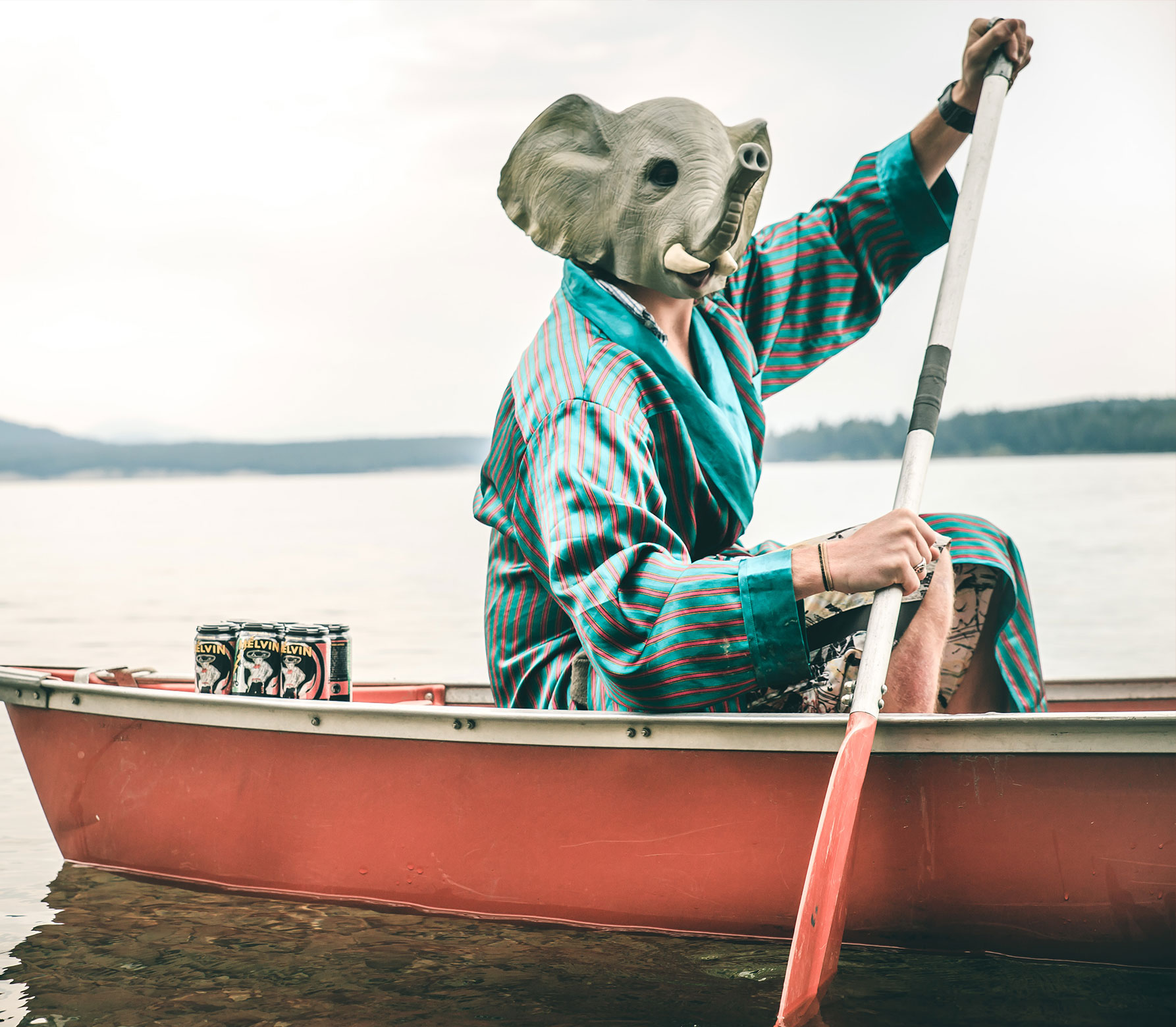 Person with elephant mask in a boat.